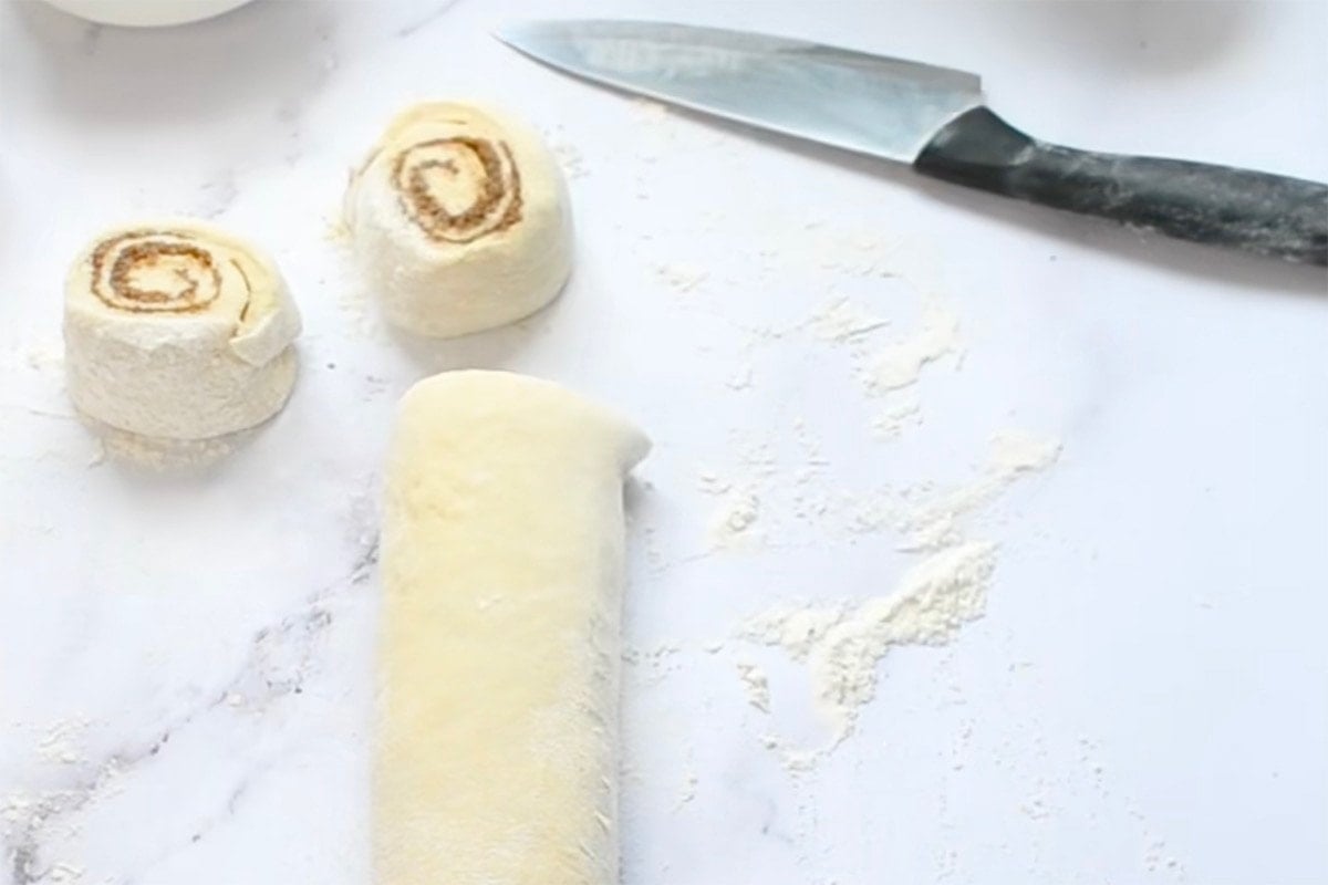 rolled cinnamon roll dough sliced.