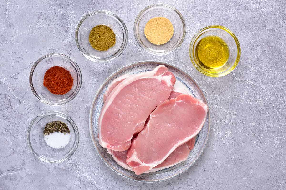 raw pork chops in a bowl.