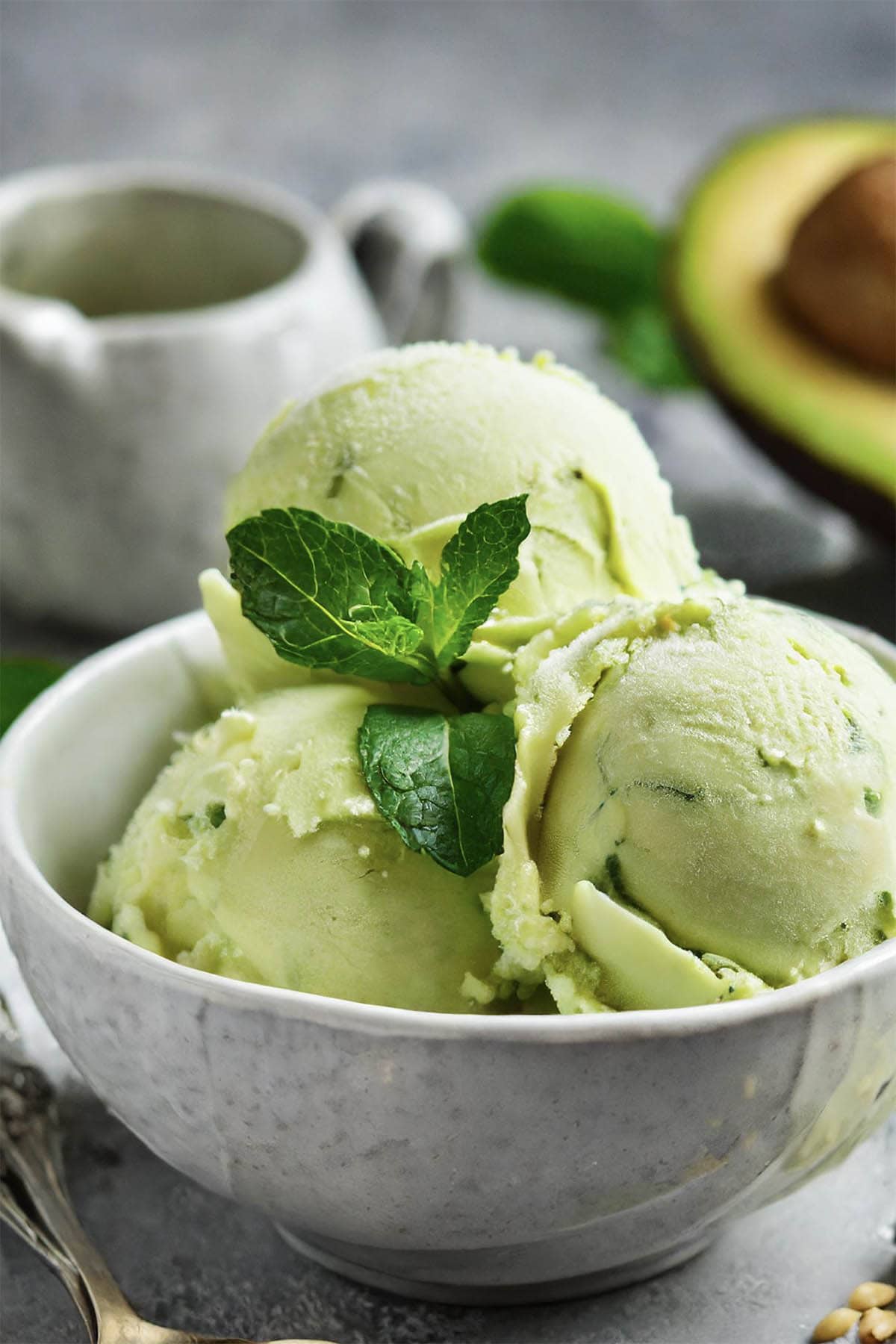 avocado ice cream in bowl with fresh mint.