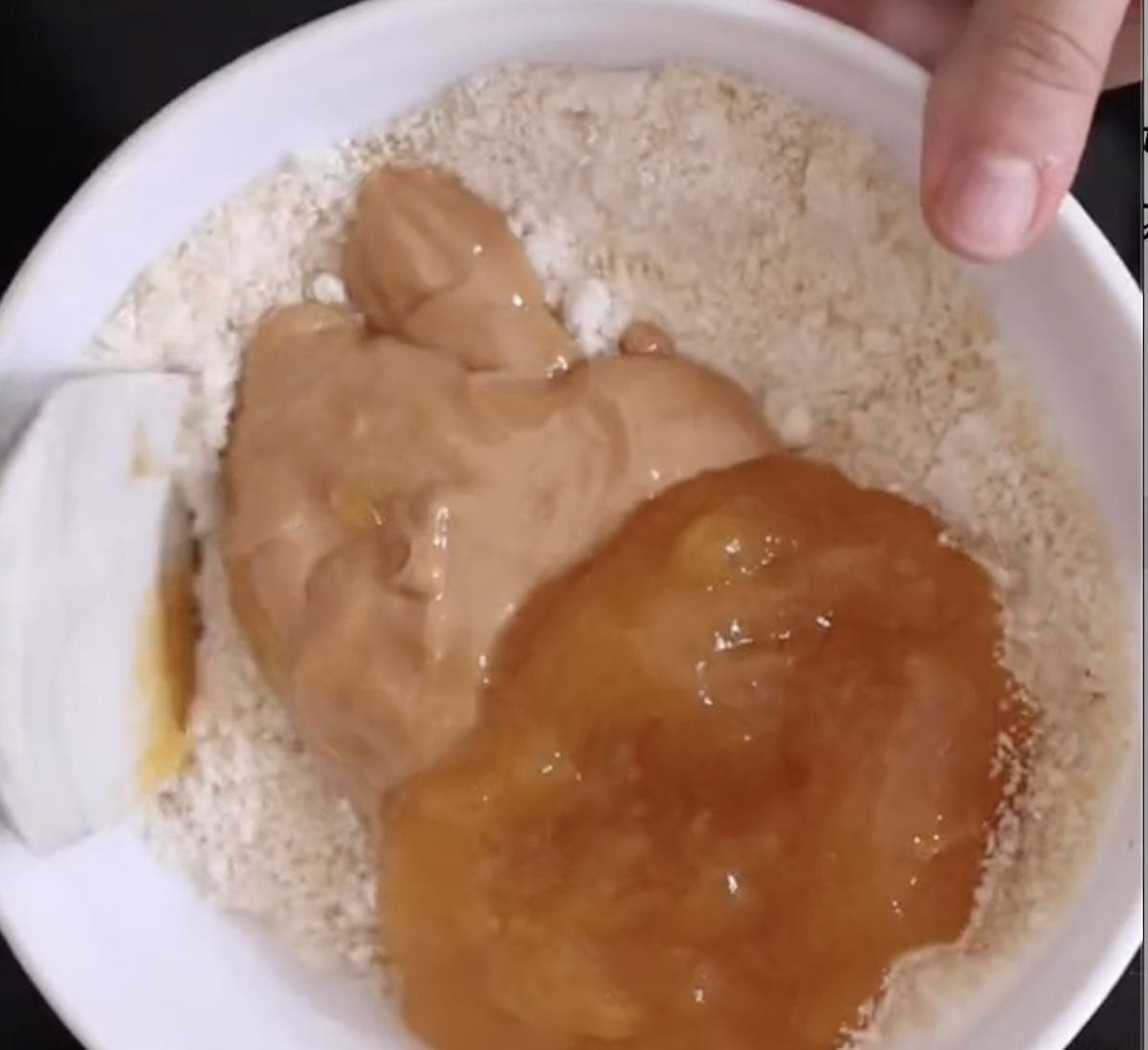 almond flour, protein powder, peanut butter, and applesauce in a mixing bowl.