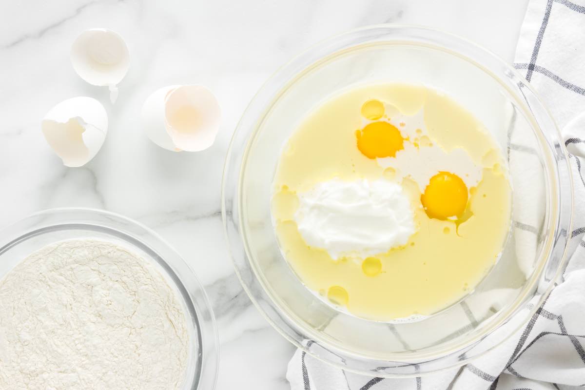 yogurt, milk, eggs, and butter in a bowl.