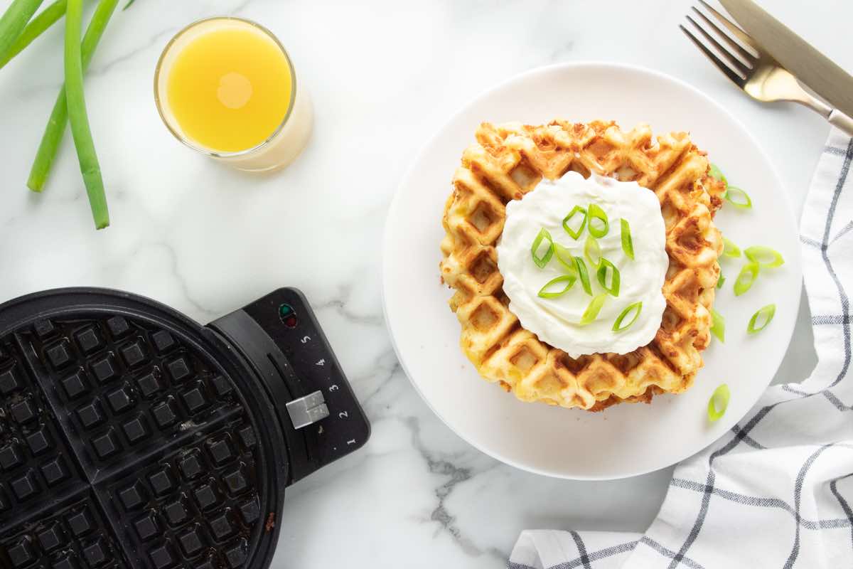 savory waffles with sour cream and green onion on top. 