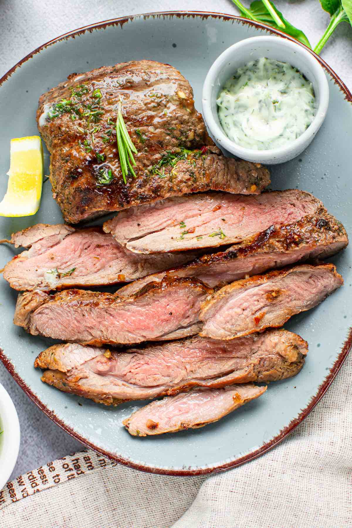 bavette steak on a plate with garlic butter.