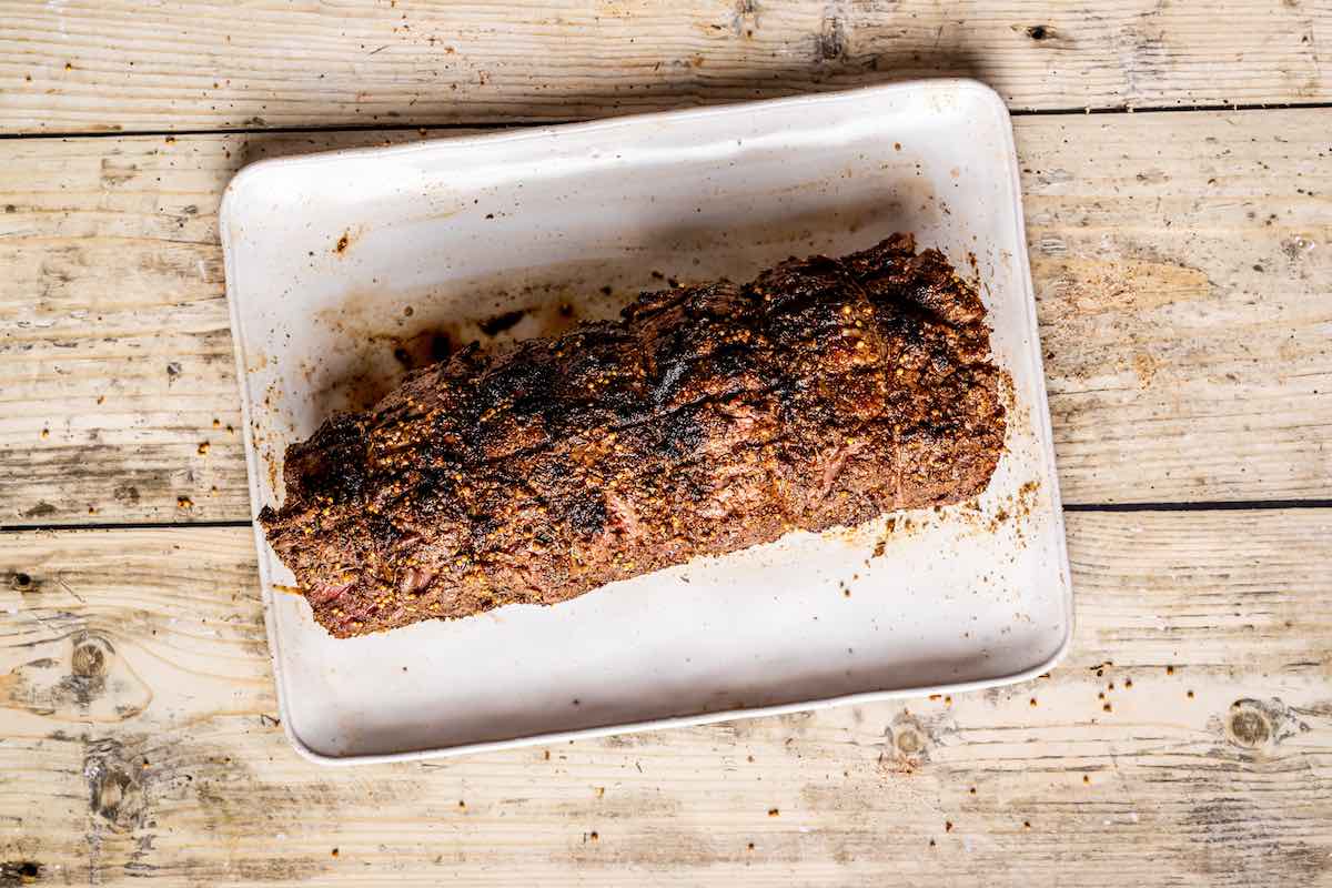grilled beef tenderloin resting on a pan.