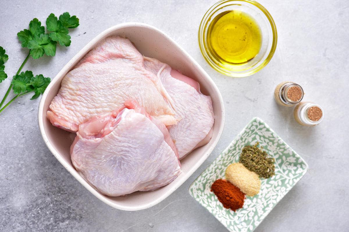 raw chicken thighs in a bowl.