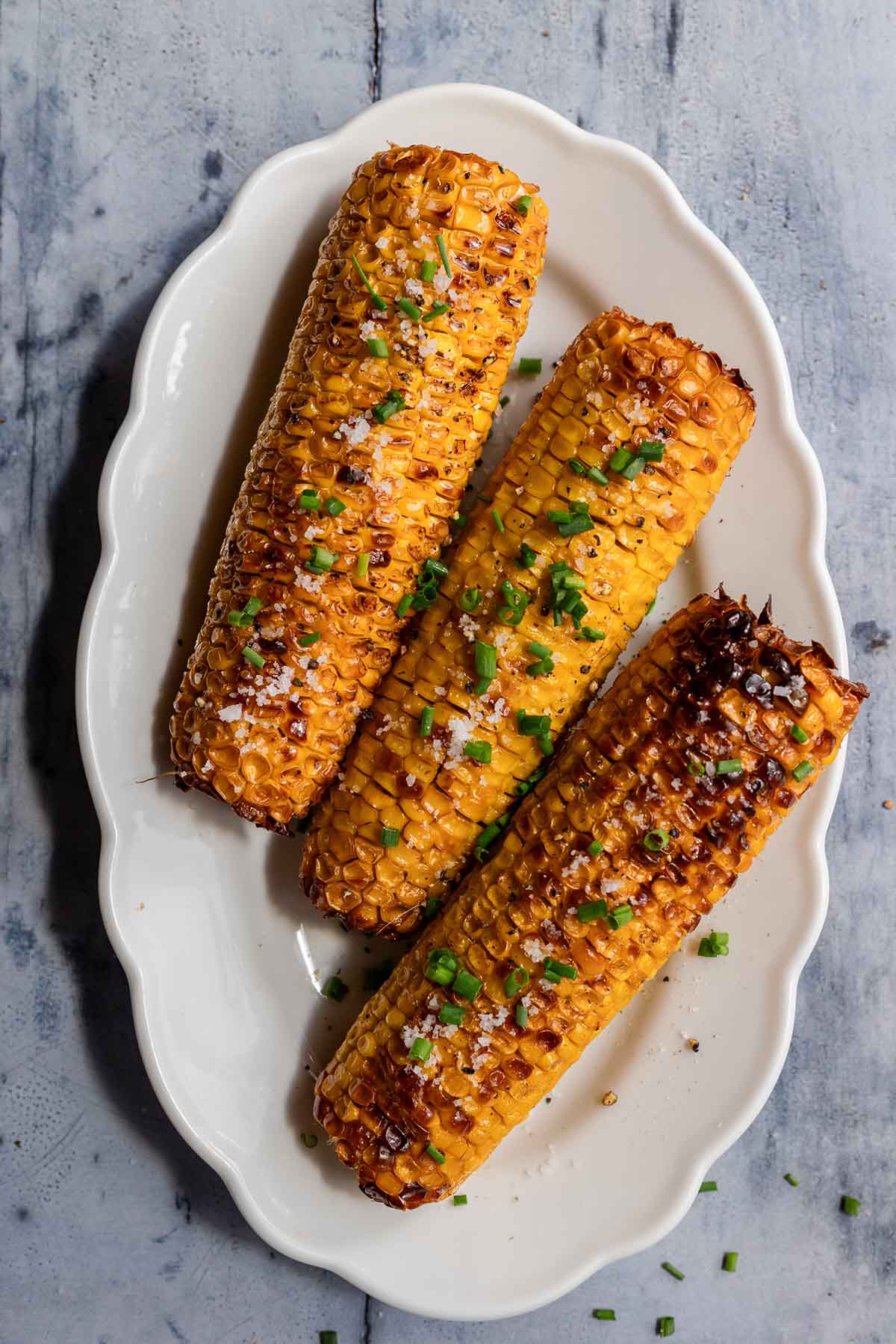 air fried corn on the cob with flaky salt and butter on top.