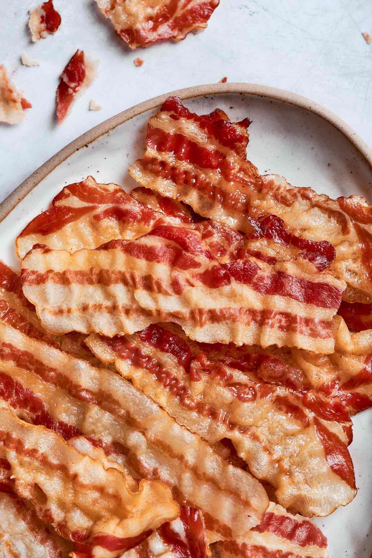 crispy air fryer bacon on a white plate.