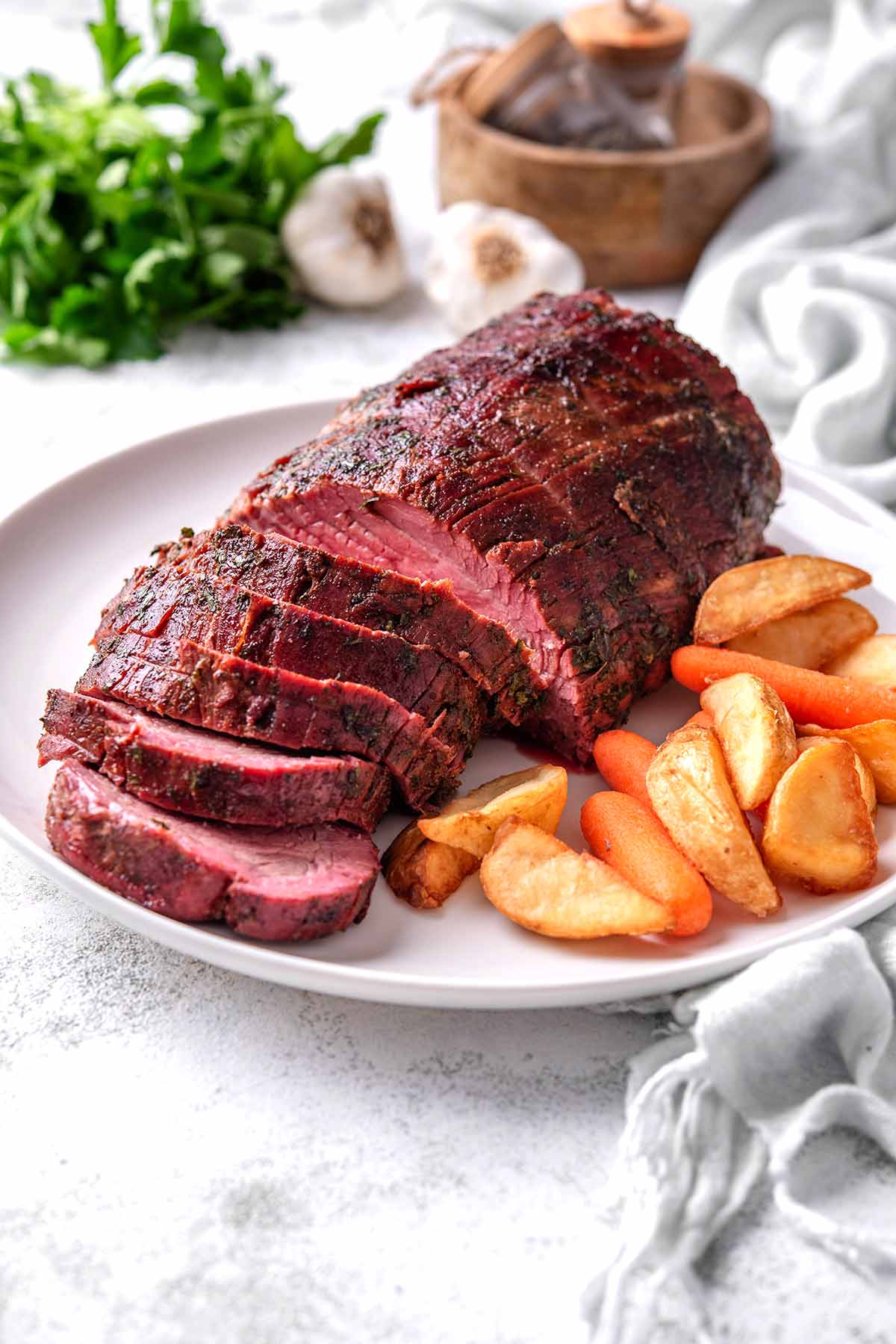 beef tenderloin smoked on a white plate.