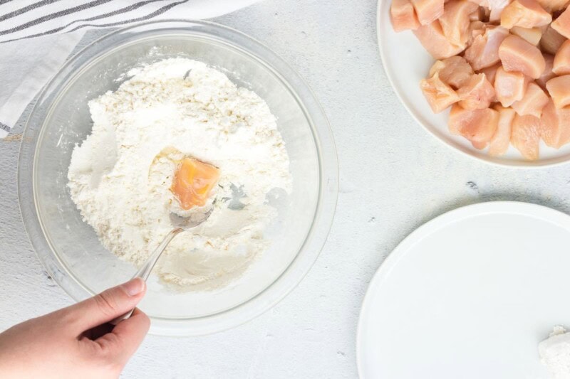 dredging chicken in cornstarch.