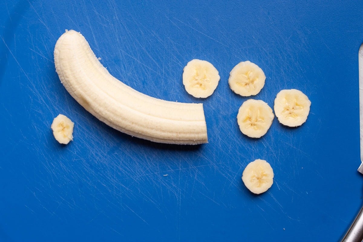 sliced banana on a chopping board.