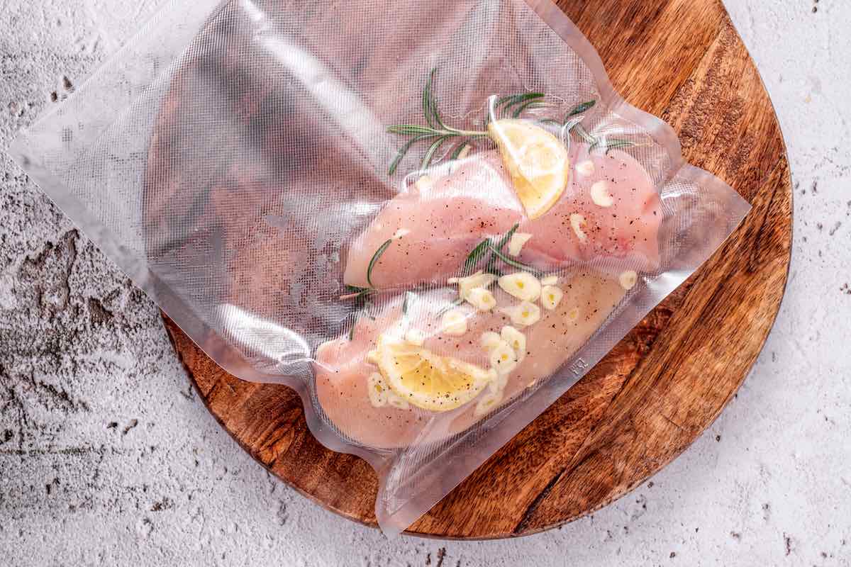 raw chicken breasts vacuum sealed in bags.