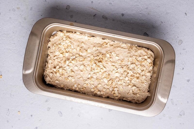 oat bread dough in baking pan.