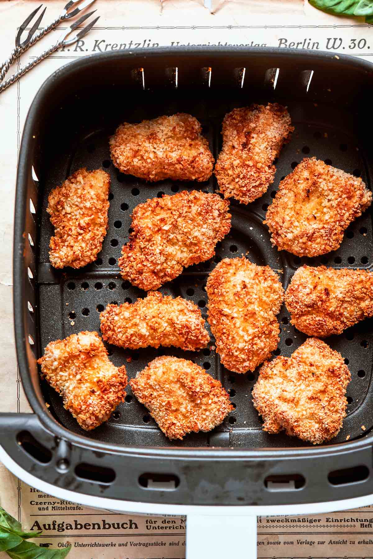 air fryer chicken nuggets in air fryer basket.