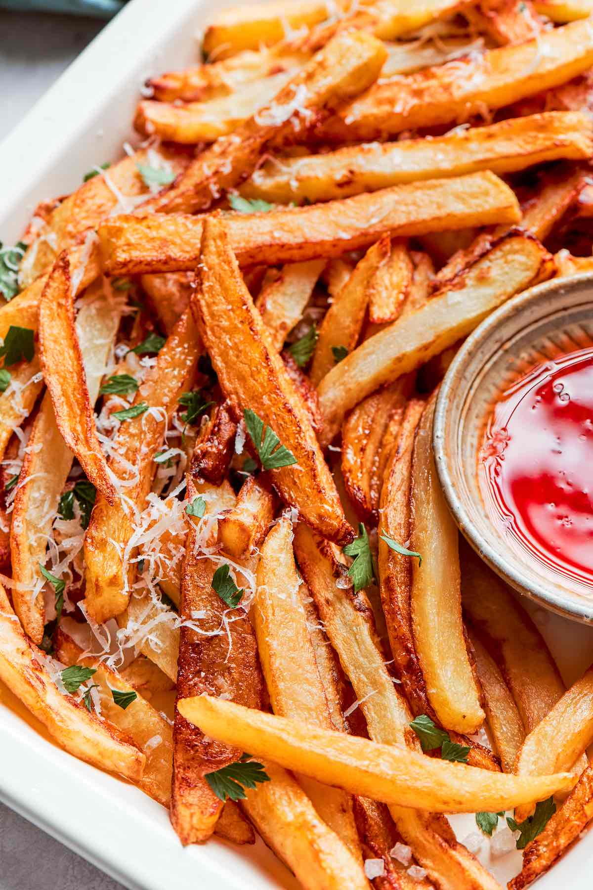 crispy air fryer French fries with parmesan and fresh herbs.