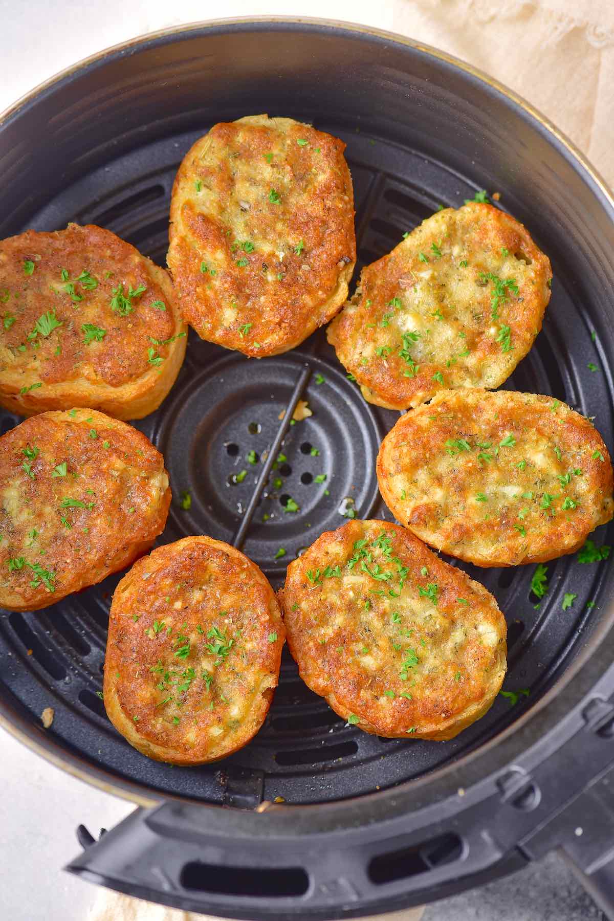 air fryer garlic bread in the air fryer basket.