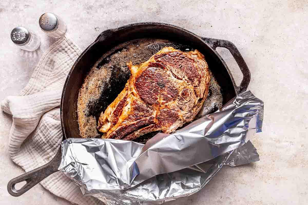 baked steak in skillet.