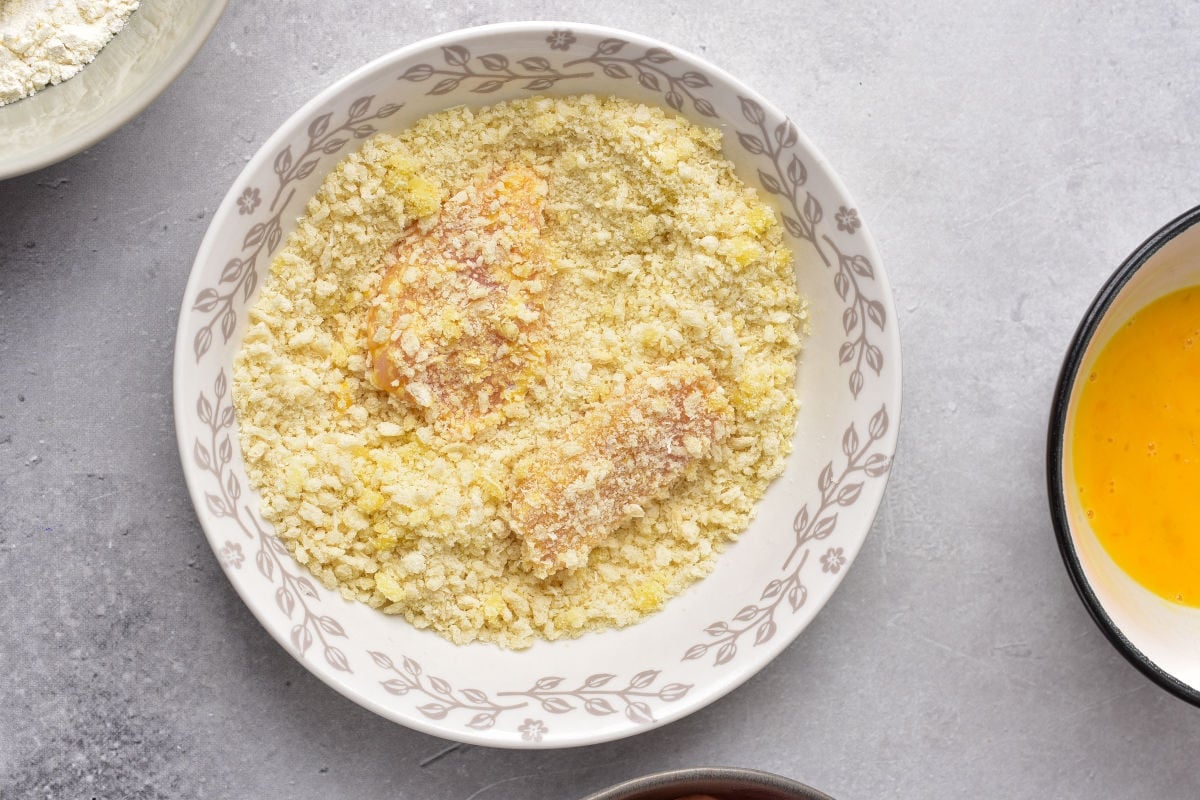 breading chicken breast pieces.