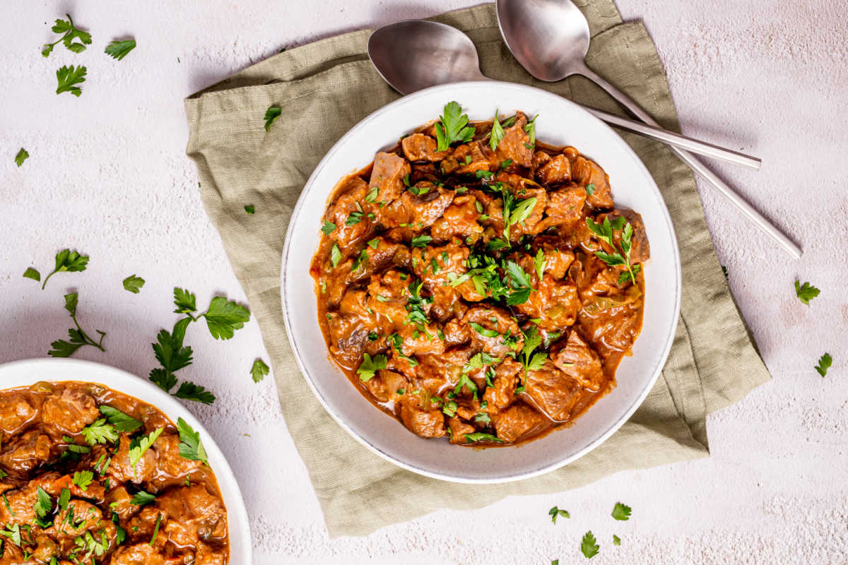 carne guisda served with fresh parsley on top.