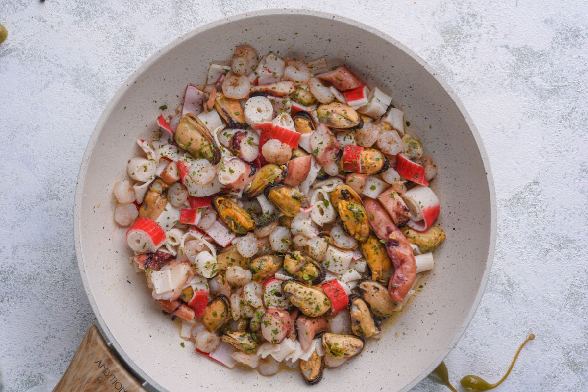 mixed cooked seafood in a skillet.