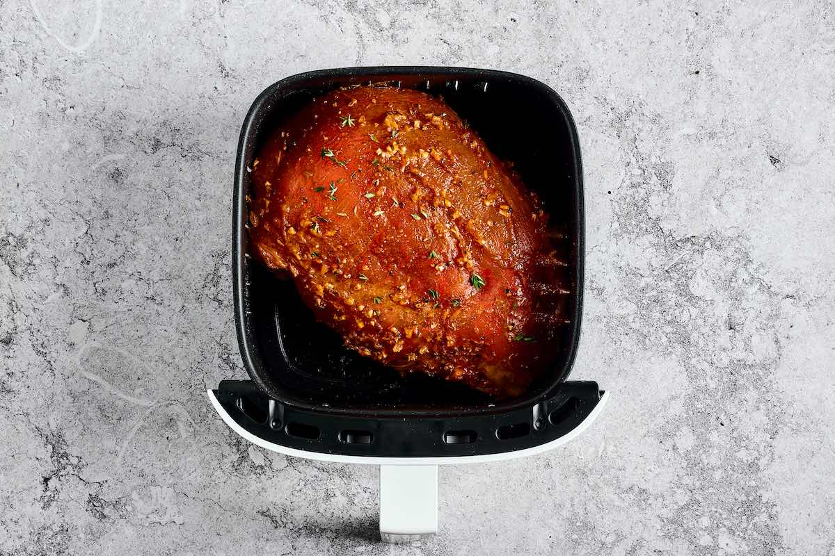 seasoned and raw turkey breast in air fryer.