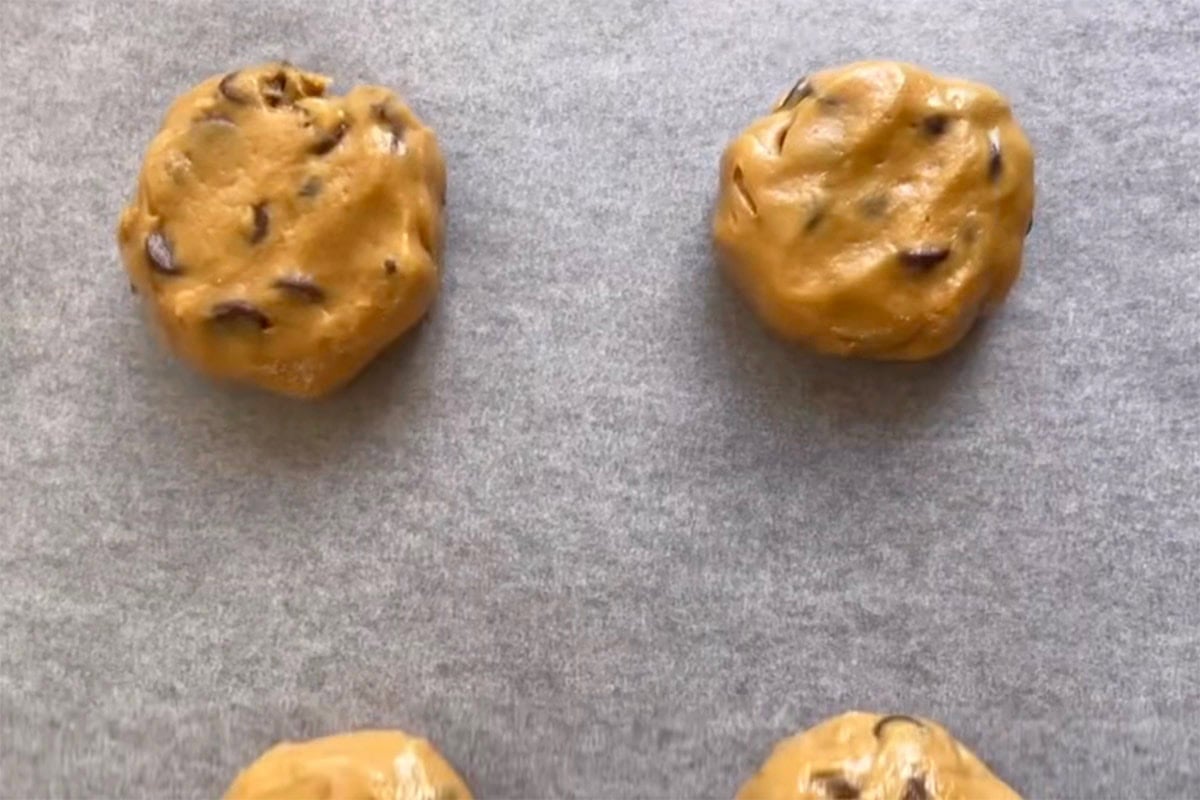 balls of cookie dough on a baking sheet. 
