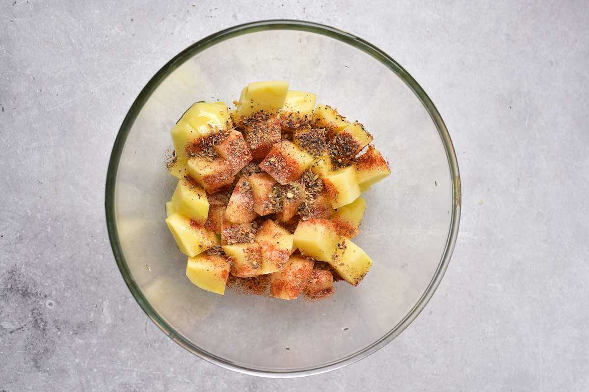 seasoned potatoes in a bowl.