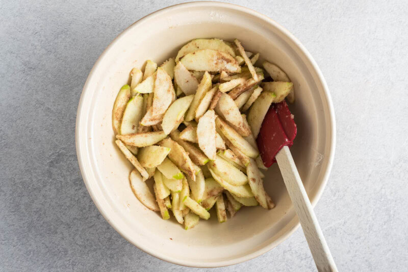 sliced apples with spices, sugar, and flour.