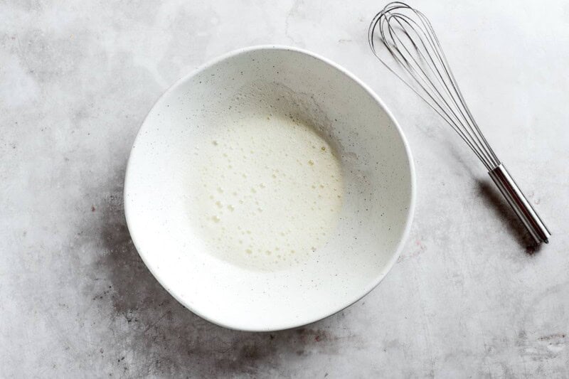 whisked egg white in a bowl.