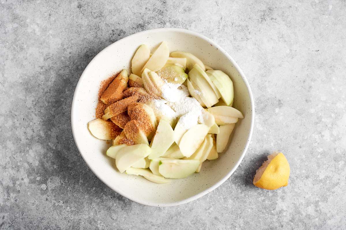 sliced apples, brown sugar, cornstarch, and lemon juice in a bowl.