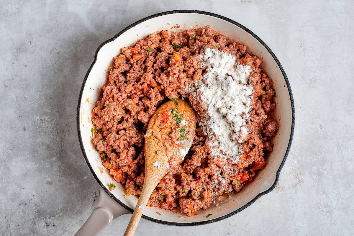 adding flour to the ground beef filling.