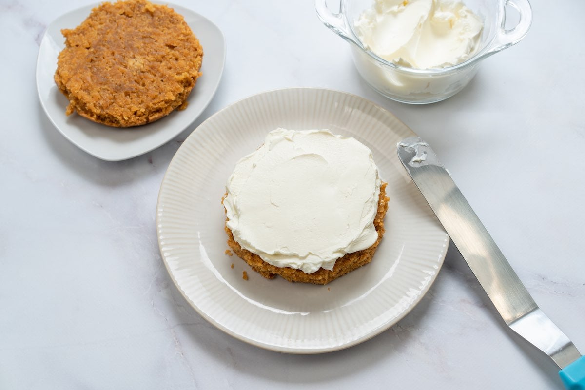 spreading frosting between each cake layer.