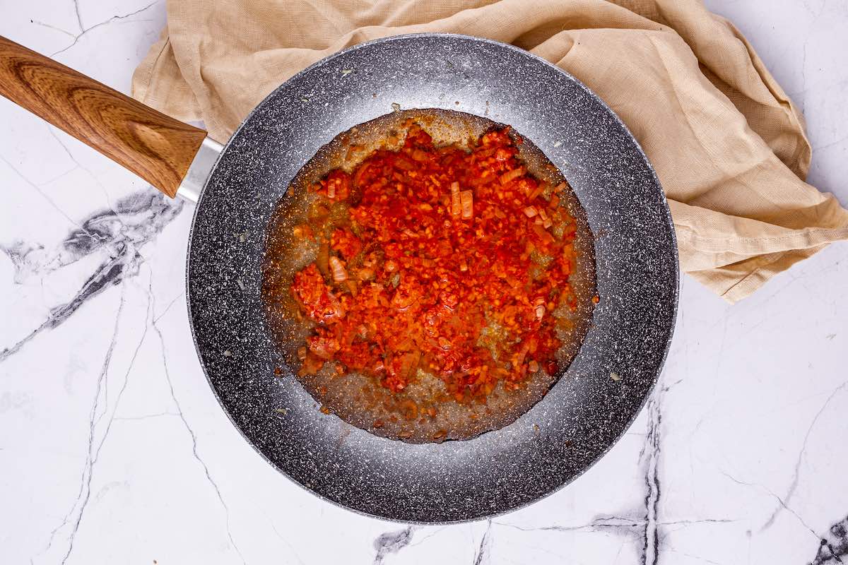 tomato paste and white wine in skillet.