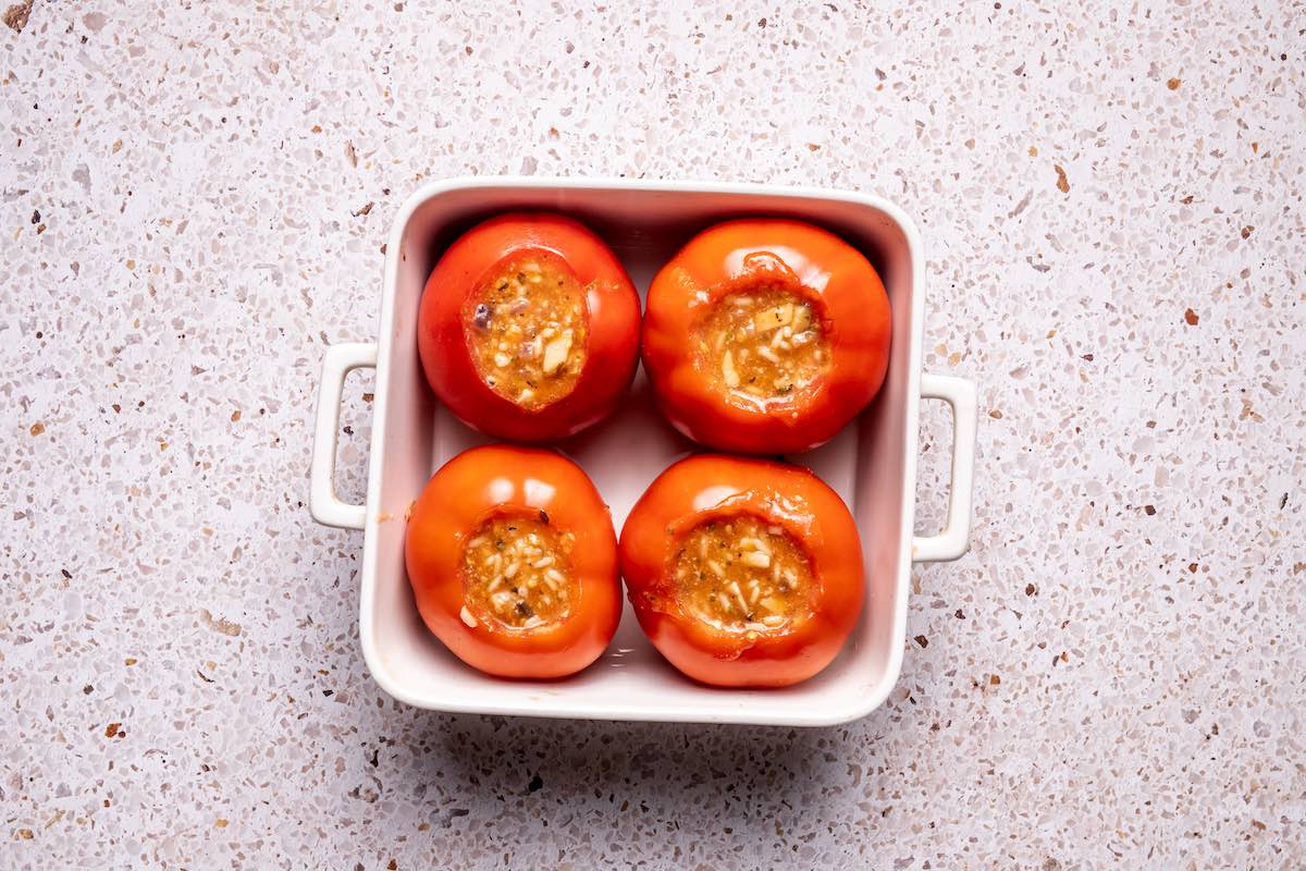 assembled and stuffed tomatoes ready to bake.