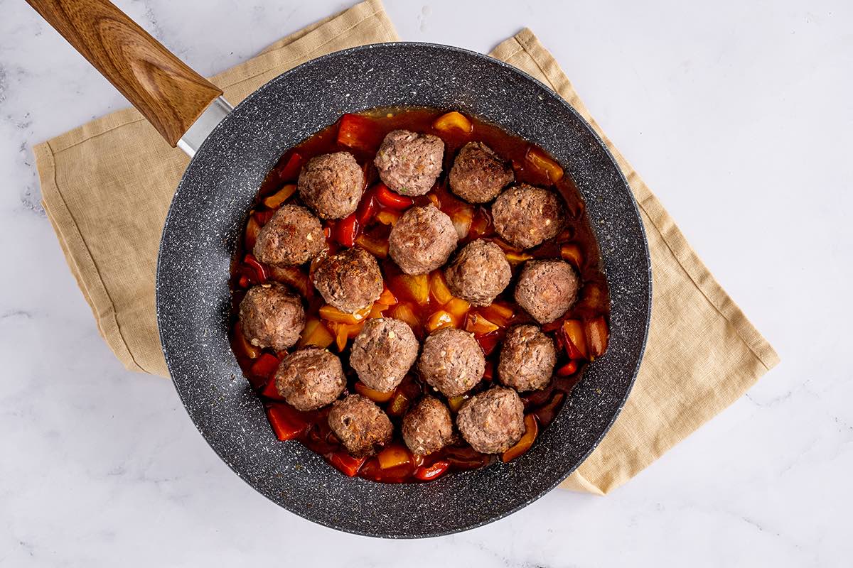 combined meatballs and sauce in a skillet.