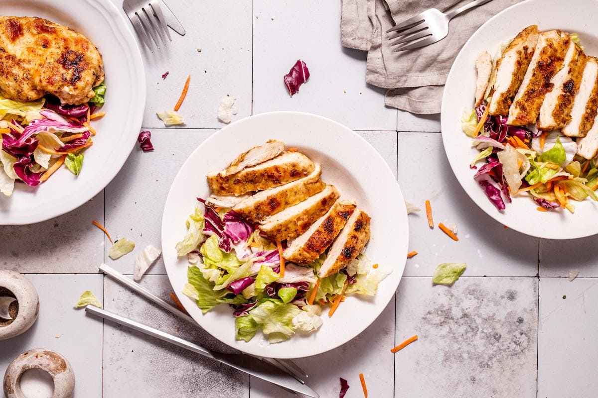 served chicken over salad.