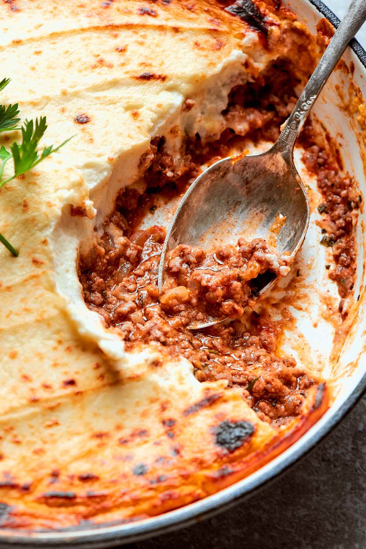 low carb shepherd's pie with a spoon showing the cauliflower topping.