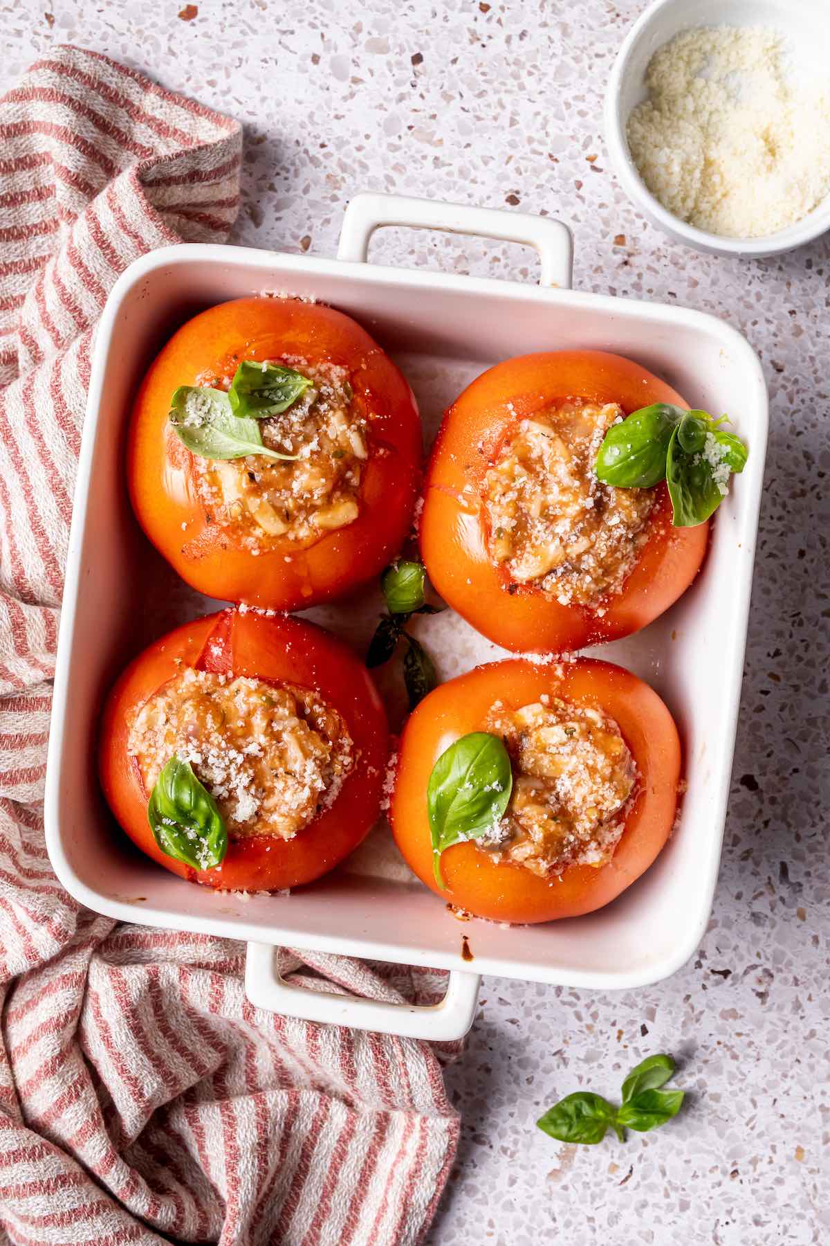 stuffed tomatoes in a baking dish.