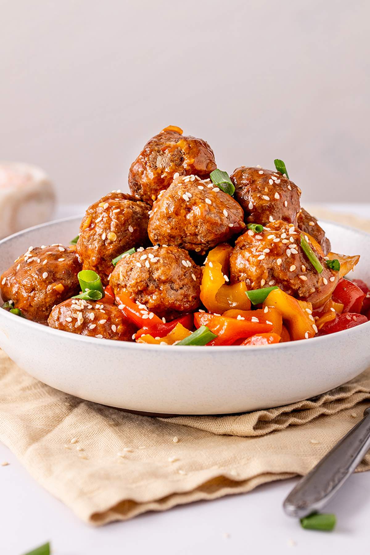 plant based meatballs in a bowl with sweet and sour sauce.