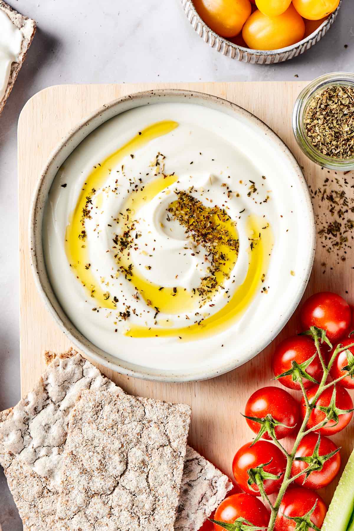 whipped cottage cheese with olive oil and herbs on top.