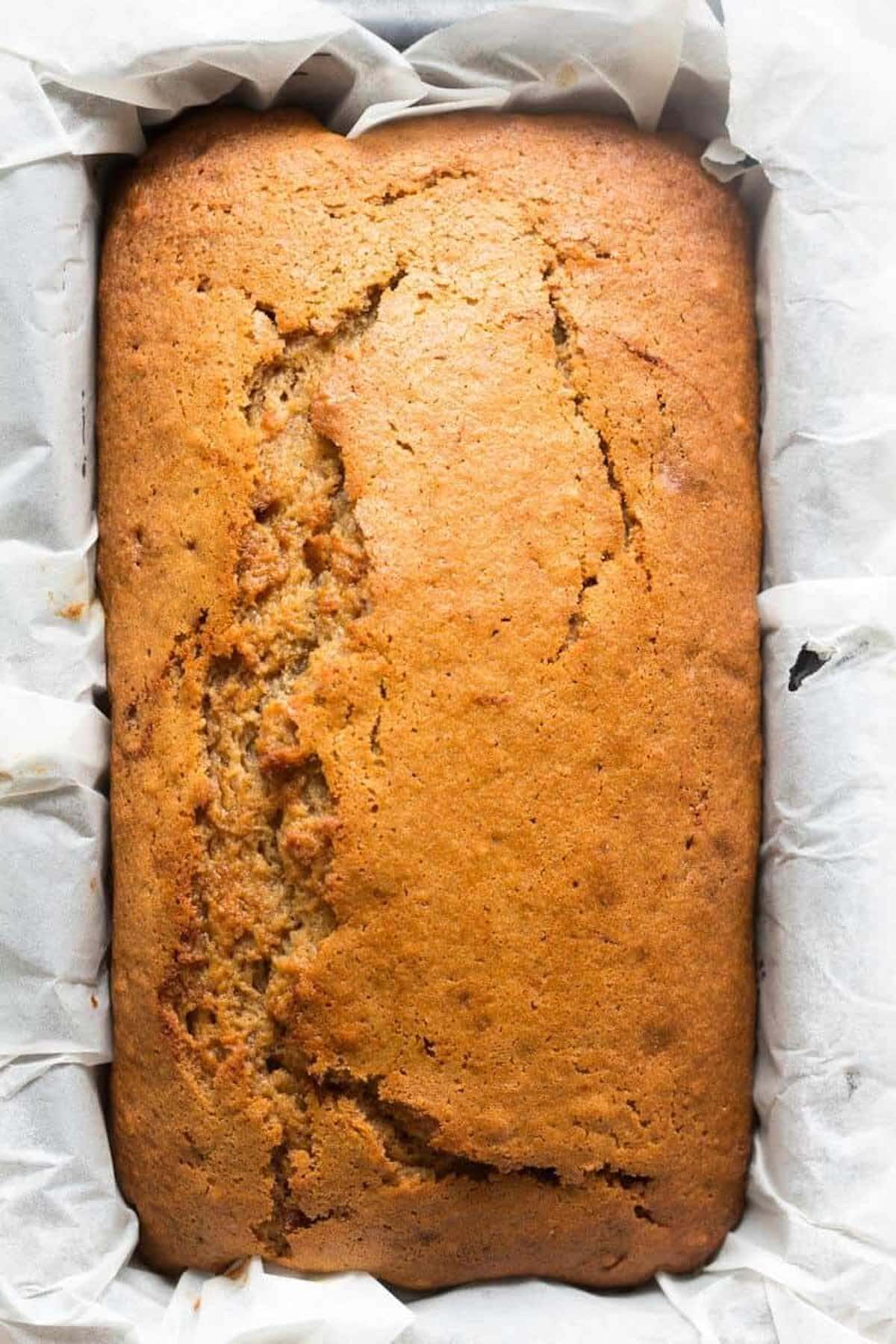 baked applesauce bread in loaf tin. 