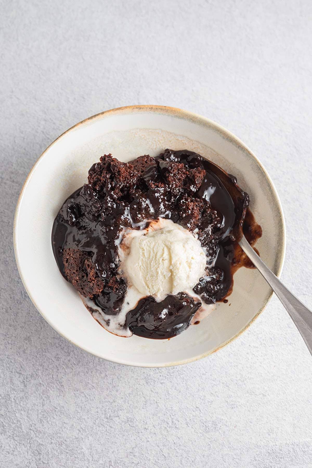 chocolate pudding cake with vanilla ice cream on top.