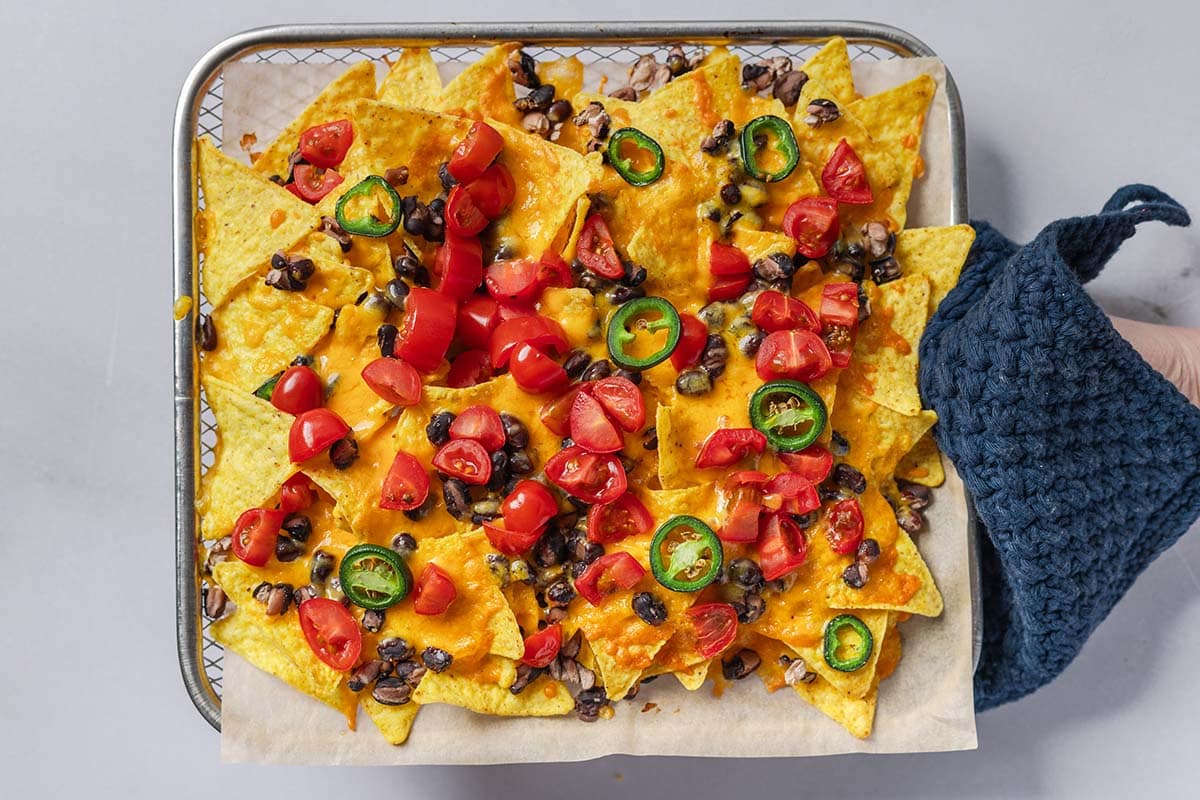 cooked nachos on air fryer tray.