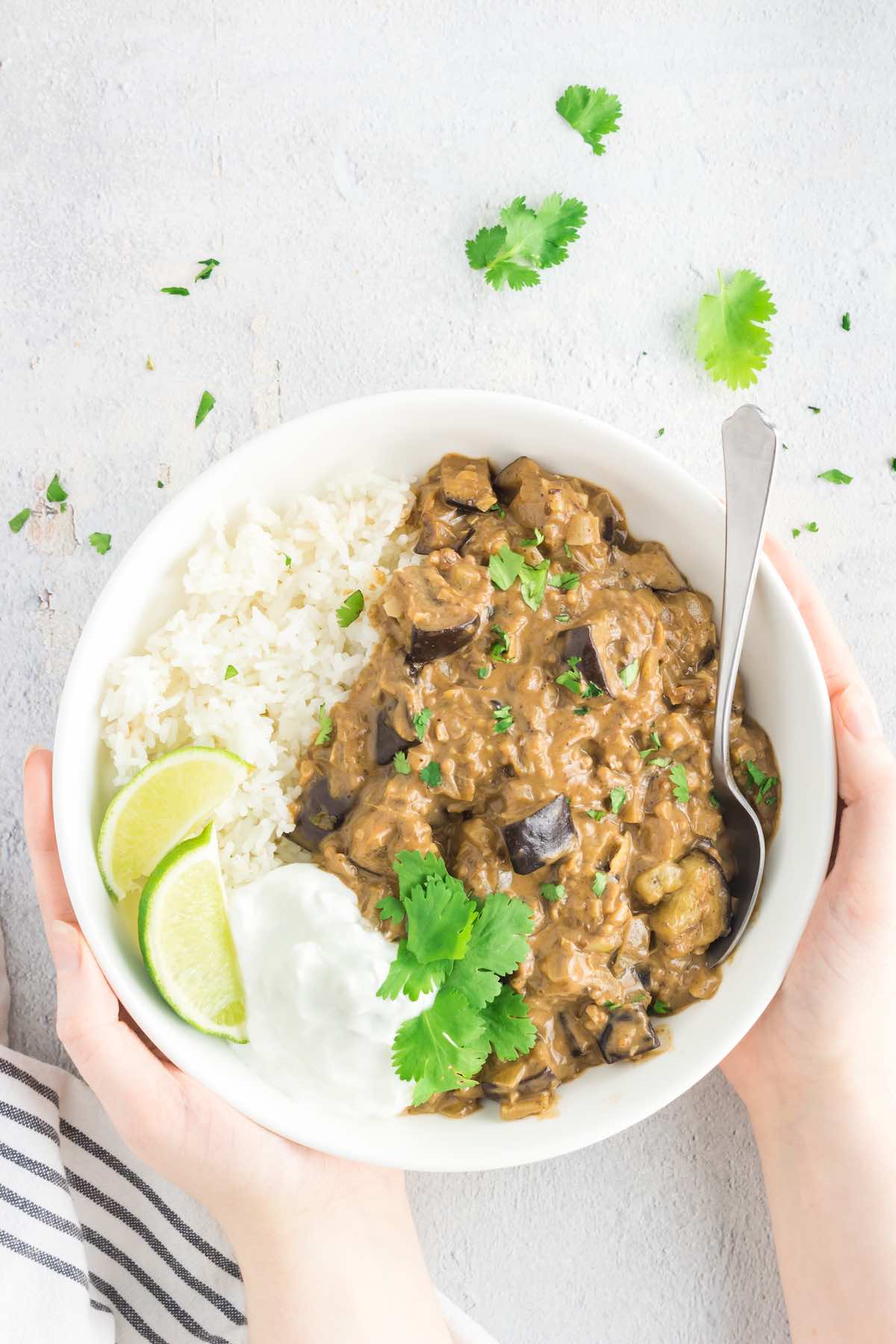 eggplant curry with rice, yogurt, and fresh lime.