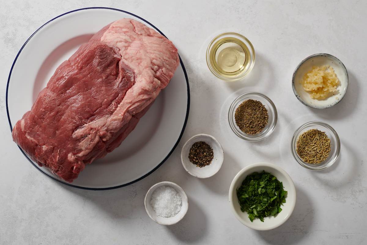 raw beef sirloin roast with seasonings.