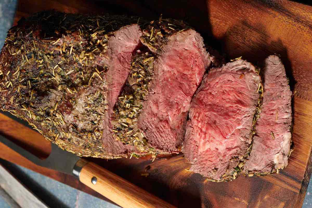 sliced beef on a chopping board.