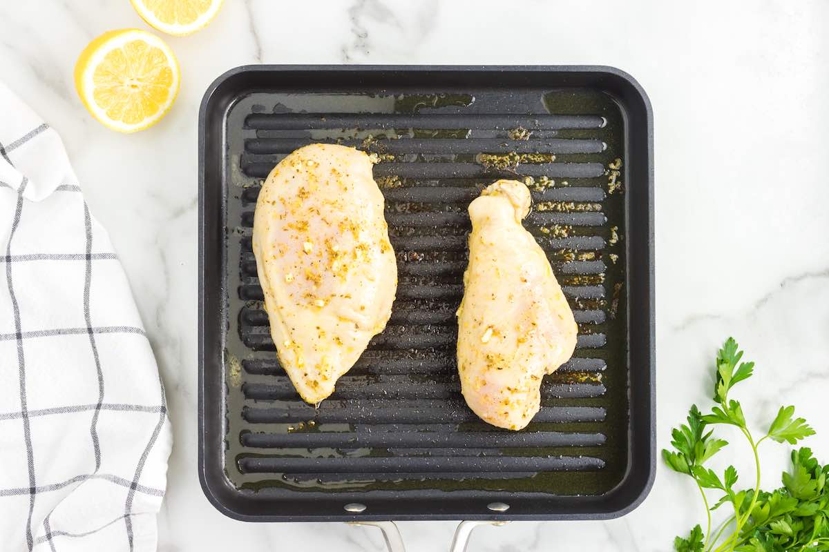 chicken breast fillets on a grill.