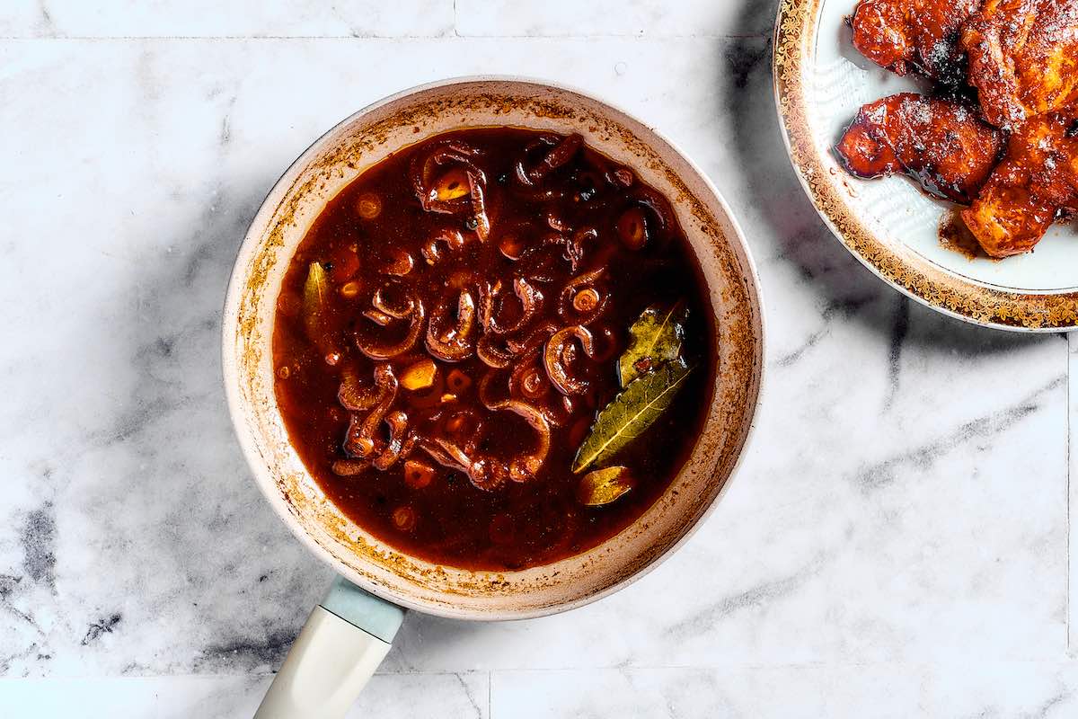 sauce thickening in a pot.