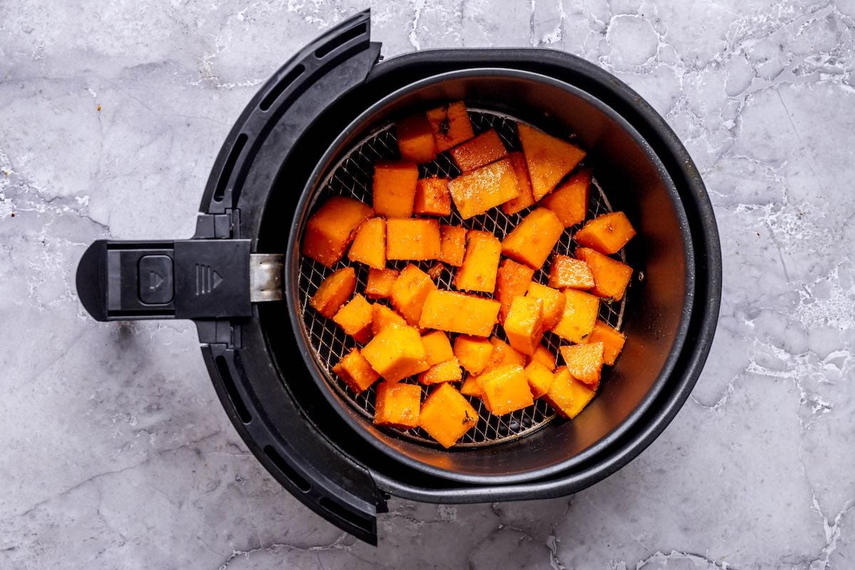 a single layer of butternut squash in the air fryer.