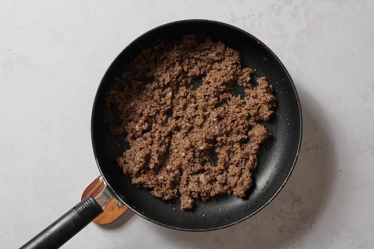 aromatics with blended mushrooms in a skillet.