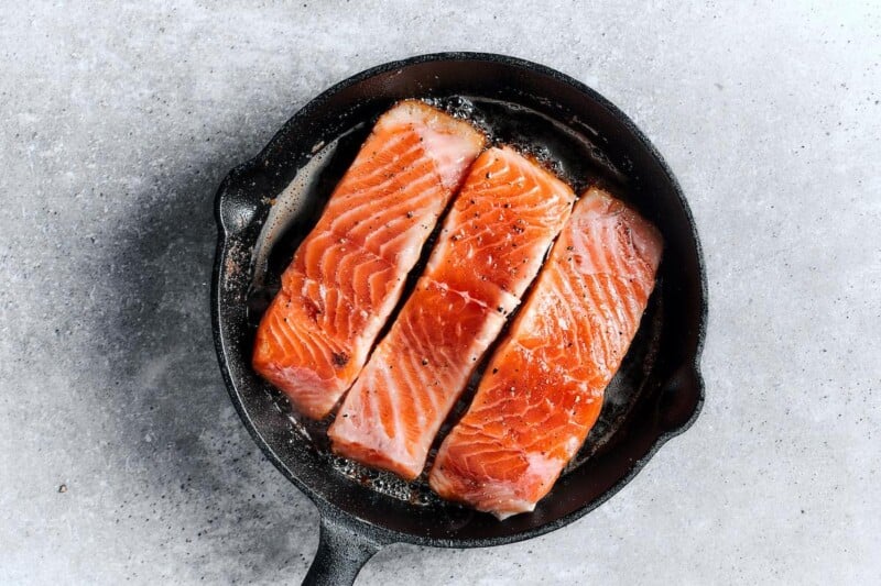 salmon sizzling in the skillet.